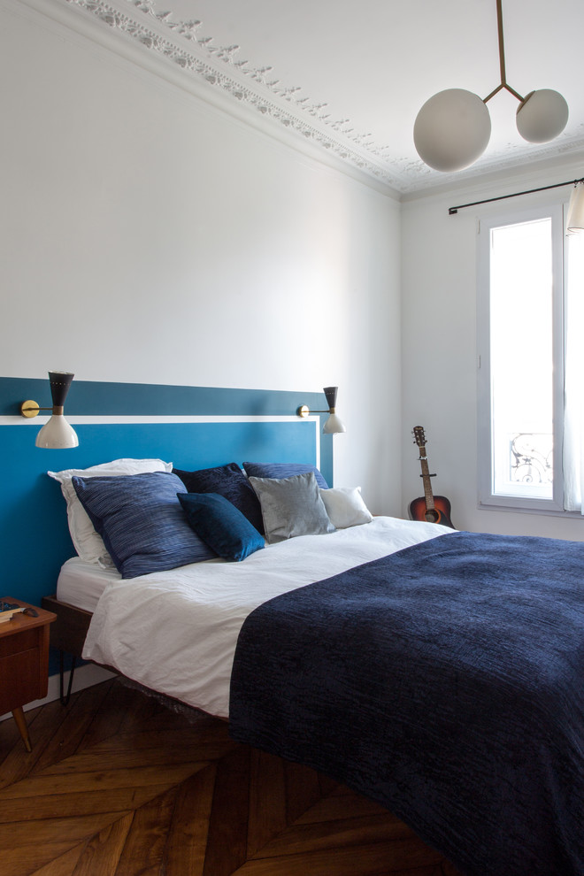 Contemporary bedroom in Paris with white walls, dark hardwood floors and brown floor.
