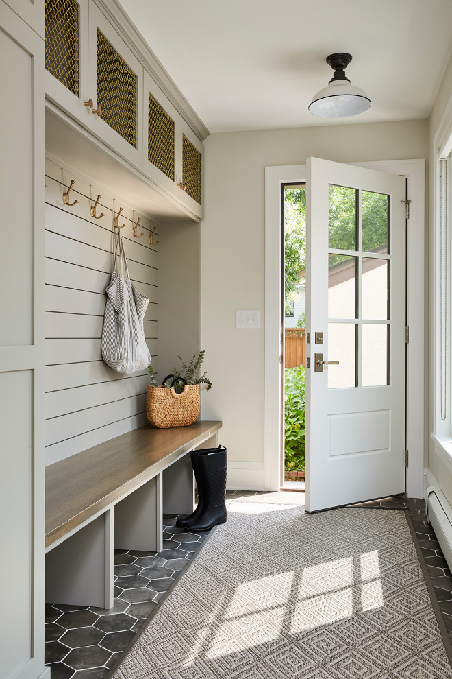 Design ideas for a mid-sized transitional mudroom in Minneapolis with beige walls and porcelain floors.