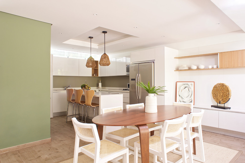 Design ideas for a small beach style kitchen/dining combo in Other with white walls, terra-cotta floors and brown floor.