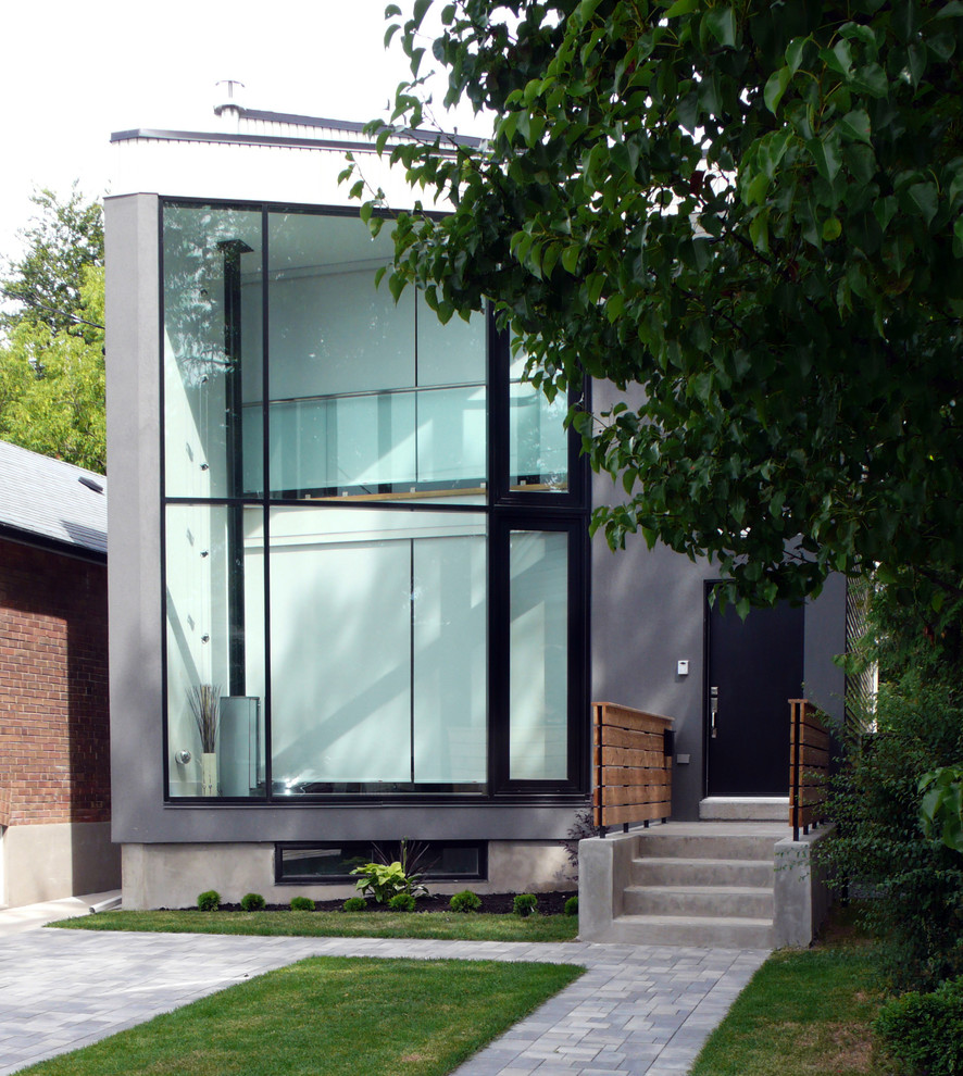 Design ideas for a modern two-storey stucco grey house exterior in Toronto.