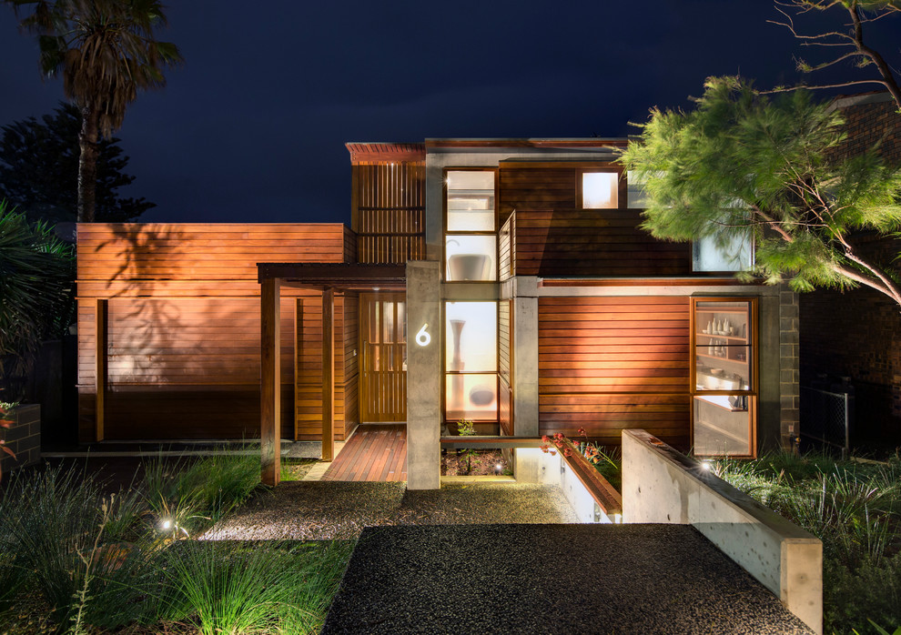 Contemporary exterior in Sydney with wood siding and a flat roof.