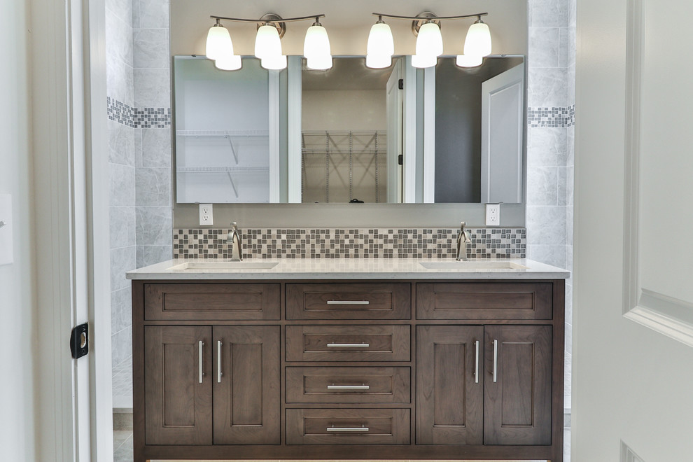 Mid-sized transitional master bathroom in St Louis with shaker cabinets, dark wood cabinets, an alcove shower, a one-piece toilet, beige tile, mosaic tile, beige walls, ceramic floors, an undermount sink, quartzite benchtops, beige floor and a hinged shower door.