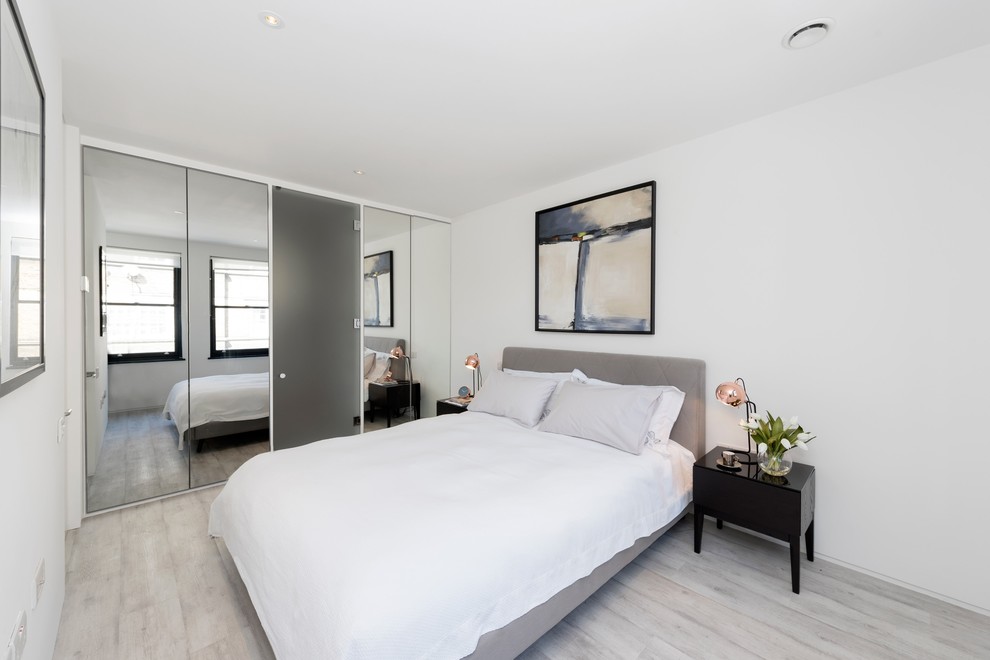 Photo of a mid-sized contemporary guest bedroom in London with white walls and no fireplace.