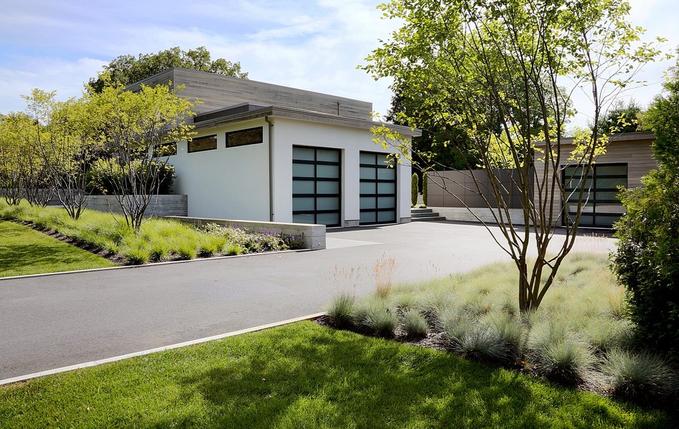 Example of a large minimalist attached two-car garage design in Boston