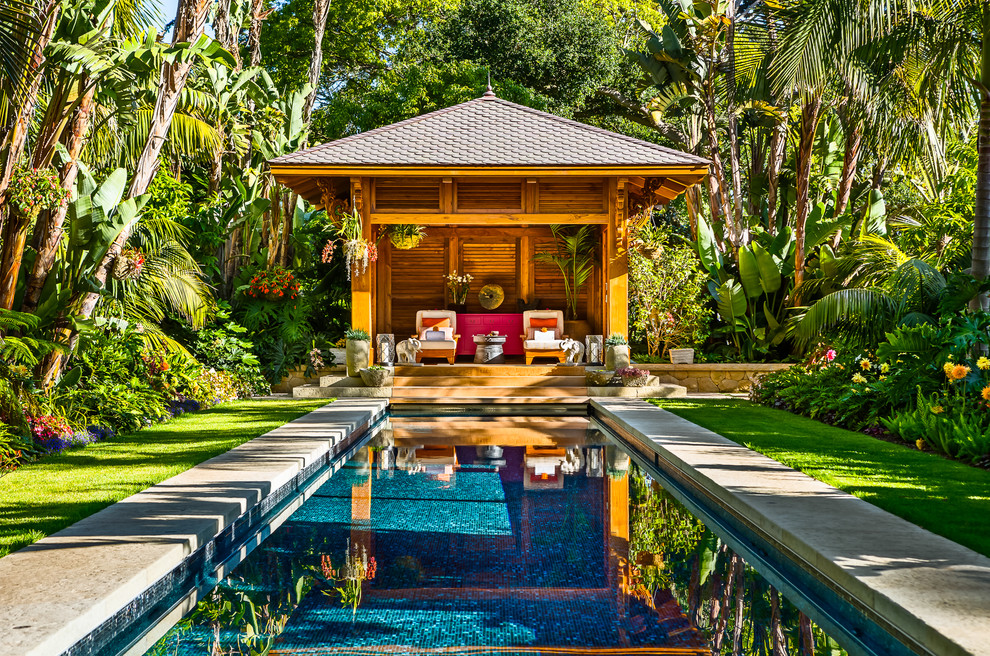 Inspiration for a large tropical rectangular pool in Santa Barbara with a pool house.