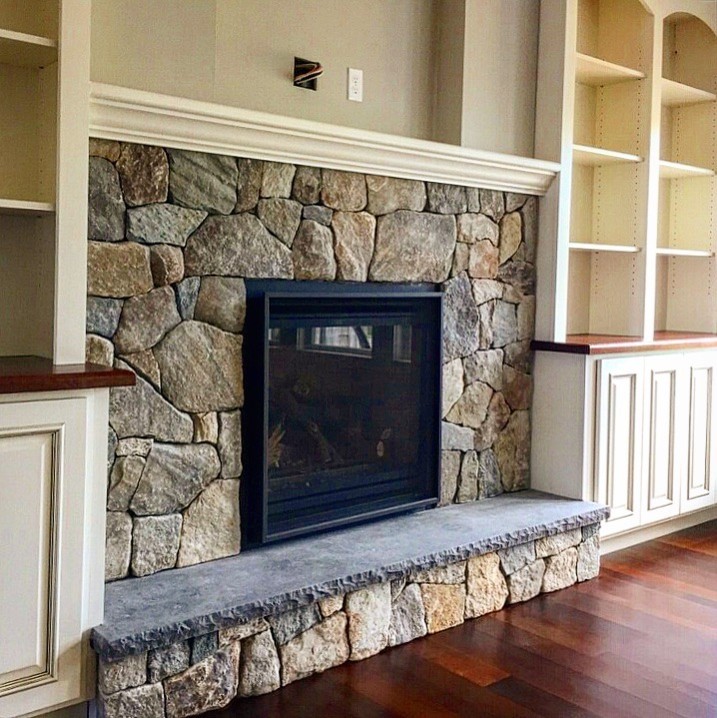 Fireplace Insert surrounded by built in shelving and cabinetry