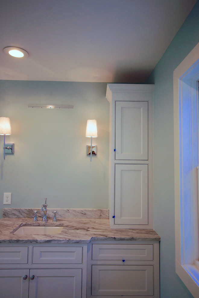Photo of a large transitional master bathroom in Cincinnati with recessed-panel cabinets, white cabinets, a freestanding tub, a corner shower, blue walls, laminate floors, an undermount sink, quartzite benchtops, grey floor, an open shower and grey benchtops.
