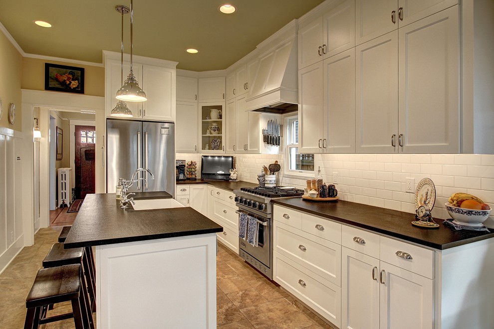 Inspiration for a large traditional l-shaped separate kitchen in Seattle with a farmhouse sink, shaker cabinets, white cabinets, quartz benchtops, white splashback, subway tile splashback, stainless steel appliances and with island.