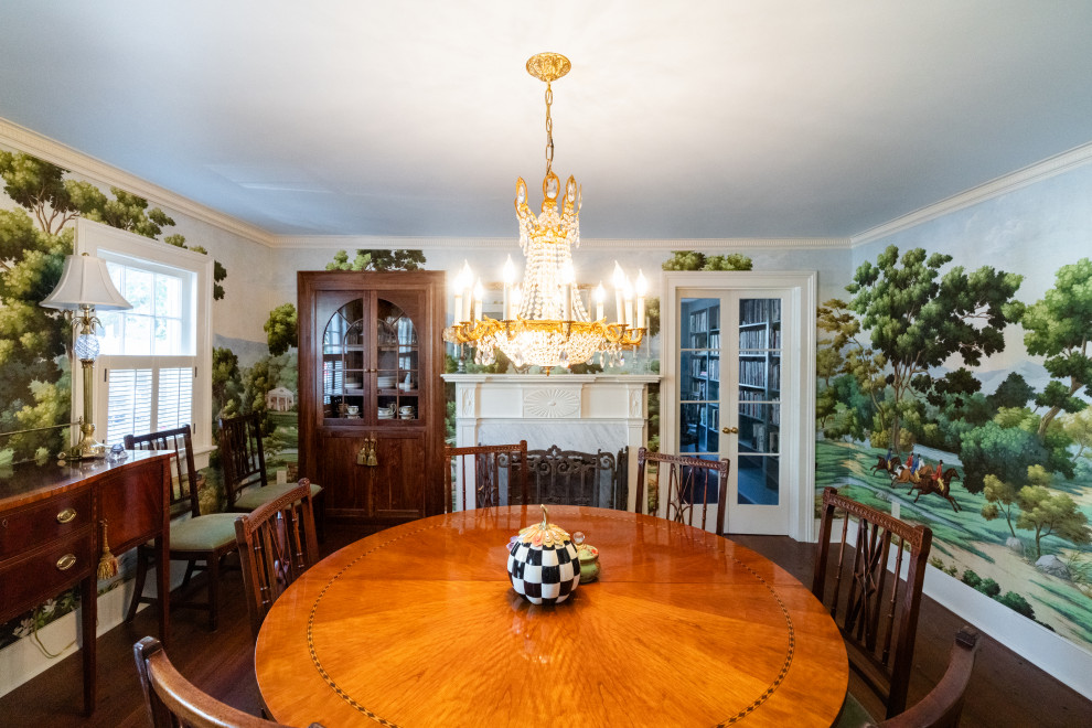 Inspiration for a mid-sized traditional separate dining room in Charleston with multi-coloured walls, dark hardwood floors, a standard fireplace, a stone fireplace surround, brown floor and wallpaper.