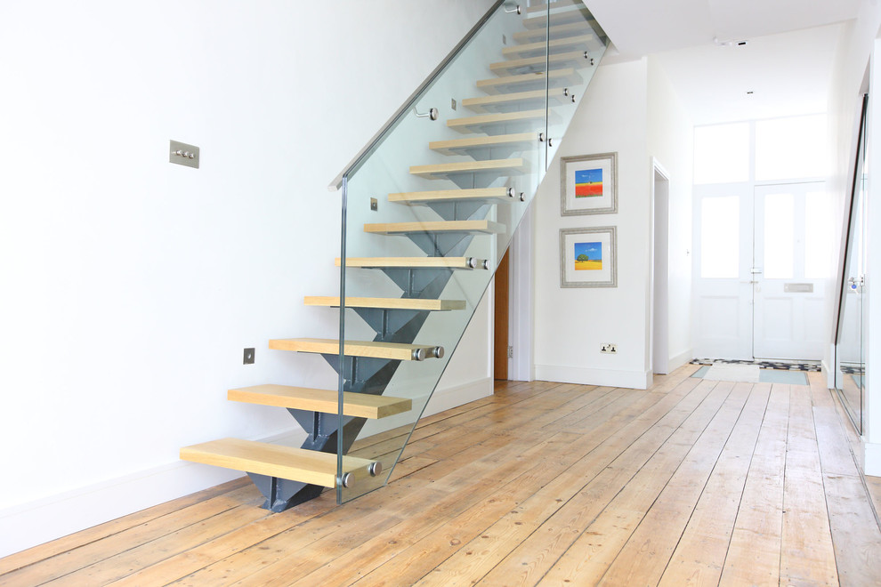 Inspiration for a contemporary wood straight staircase in London with open risers.