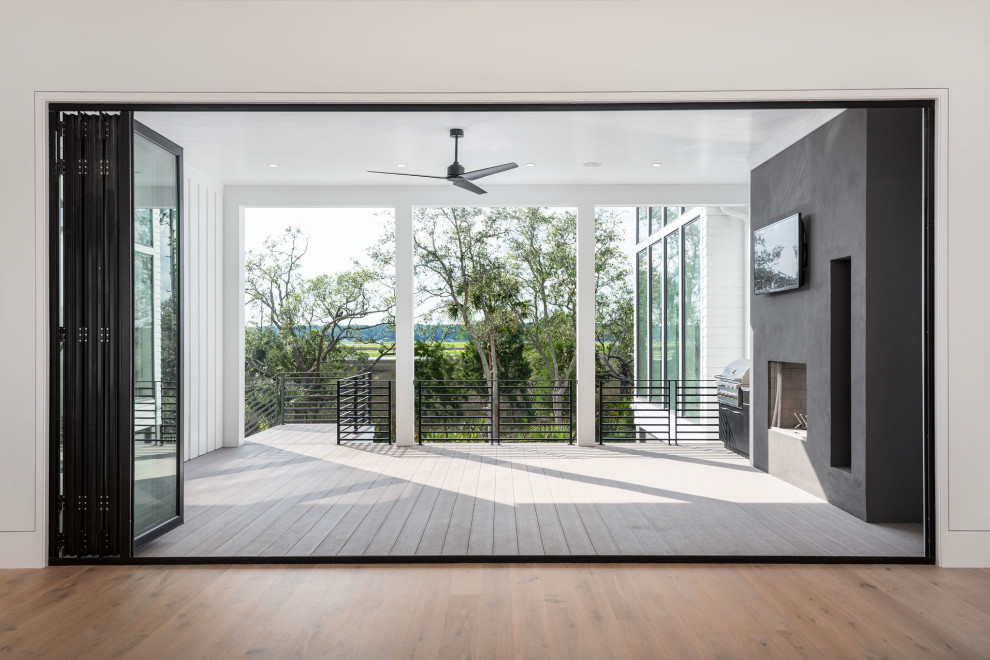 Mid-sized minimalist backyard outdoor kitchen deck photo in Charleston with a roof extension