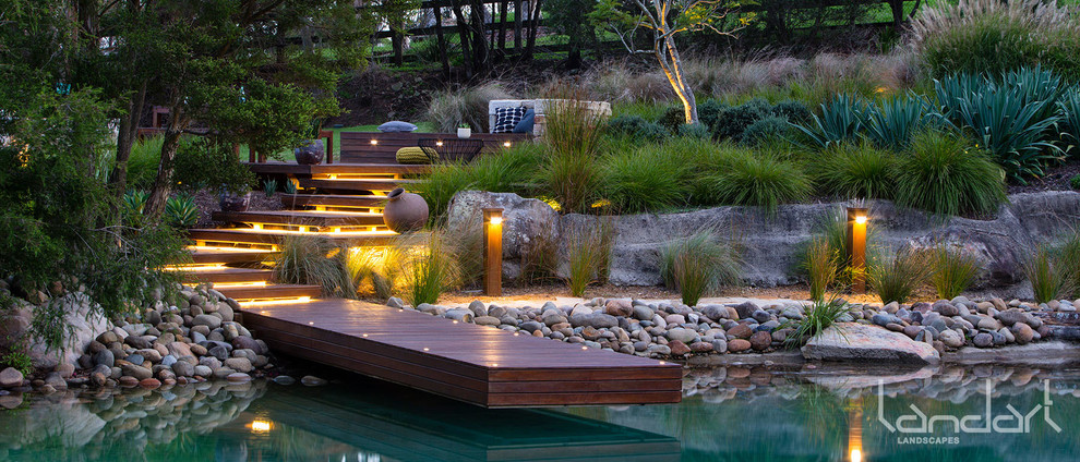 Design ideas for an expansive modern backyard full sun garden in Sydney with decking.