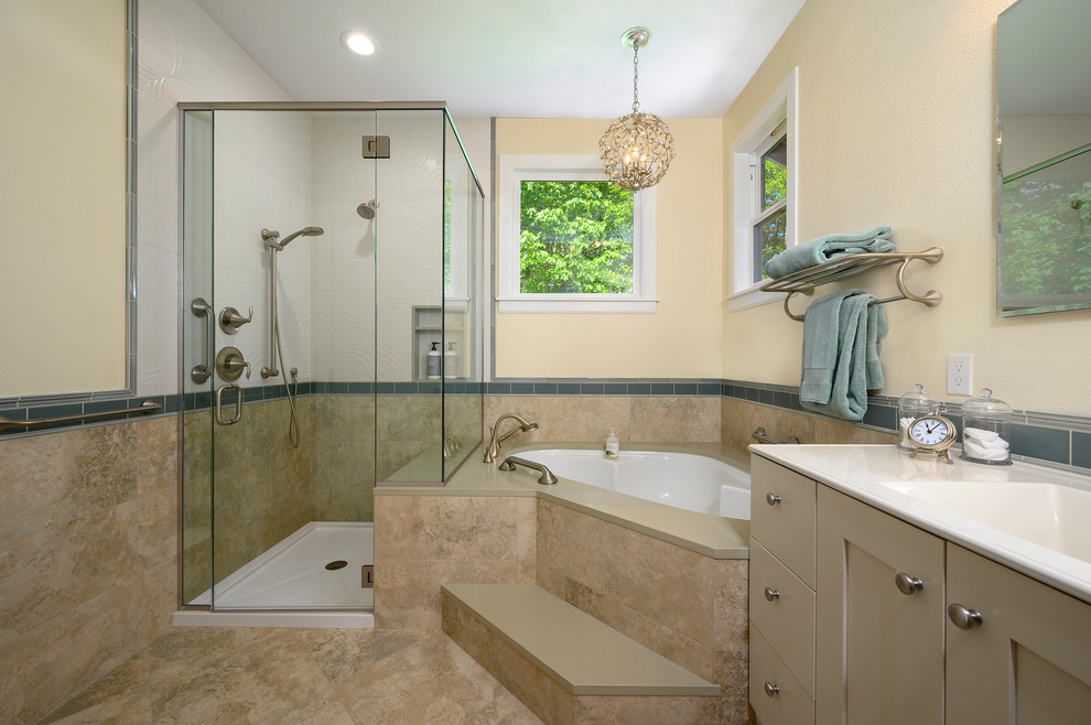 Design ideas for a mid-sized beach style master bathroom in Seattle with shaker cabinets, beige cabinets, a corner tub, a corner shower, beige tile, porcelain tile, beige walls, porcelain floors, an integrated sink, engineered quartz benchtops, beige floor, a hinged shower door and beige benchtops.