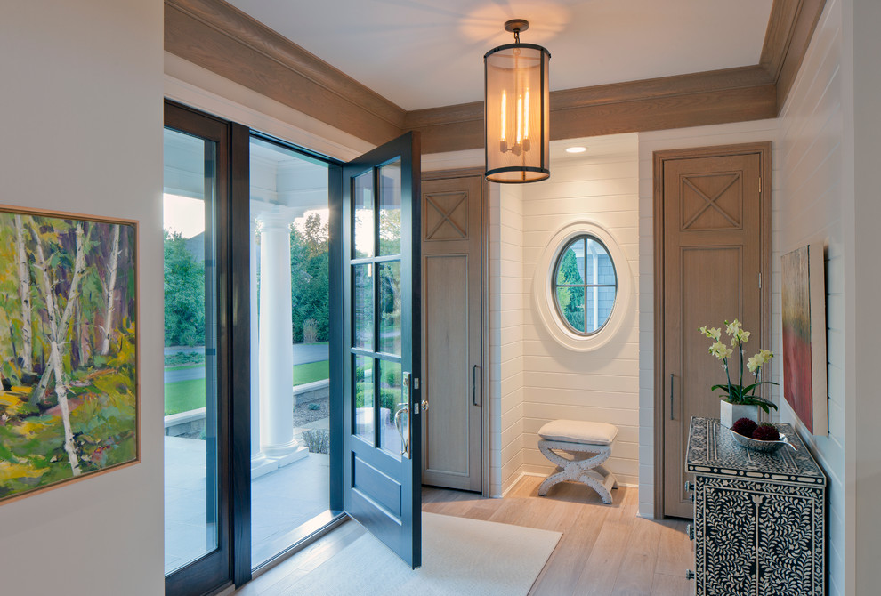 Inspiration for a transitional foyer in Grand Rapids with white walls, light hardwood floors, a single front door and a glass front door.