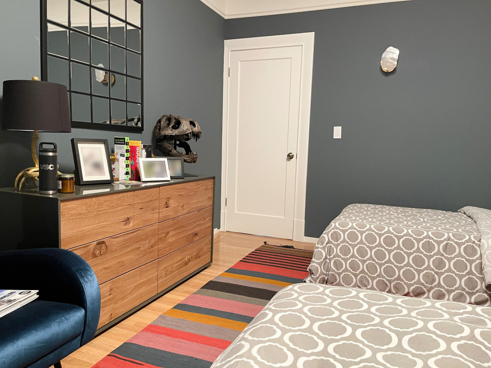 Photo of a medium sized urban teen’s room for boys in San Francisco with blue walls and light hardwood flooring.