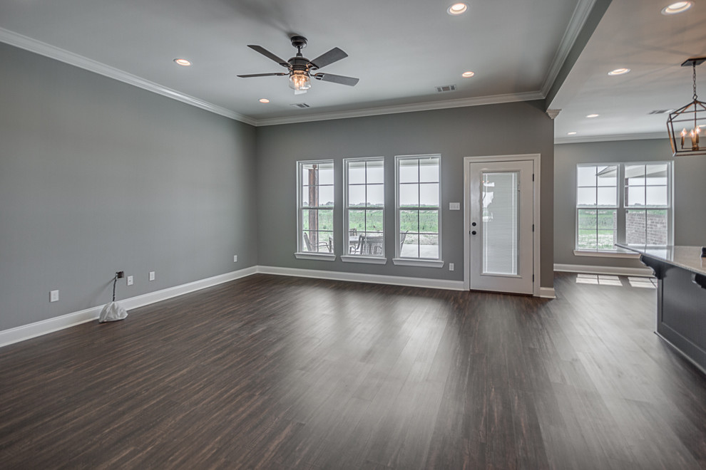Inspiration for a mid-sized arts and crafts formal open concept living room in New Orleans with grey walls, vinyl floors, no tv and brown floor.