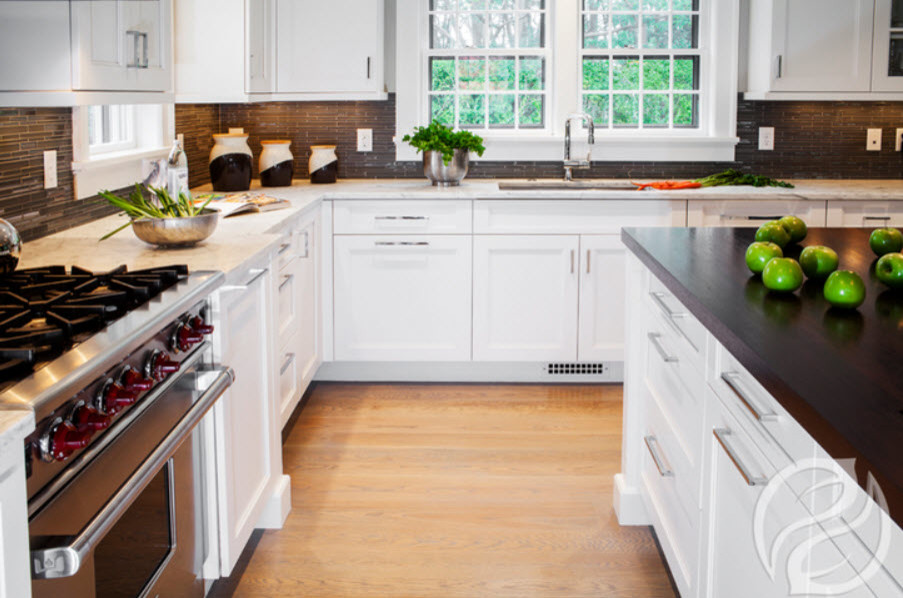 Kitchen - transitional light wood floor kitchen idea in Chicago with an undermount sink, recessed-panel cabinets, white cabinets, quartz countertops, gray backsplash, stainless steel appliances and an island