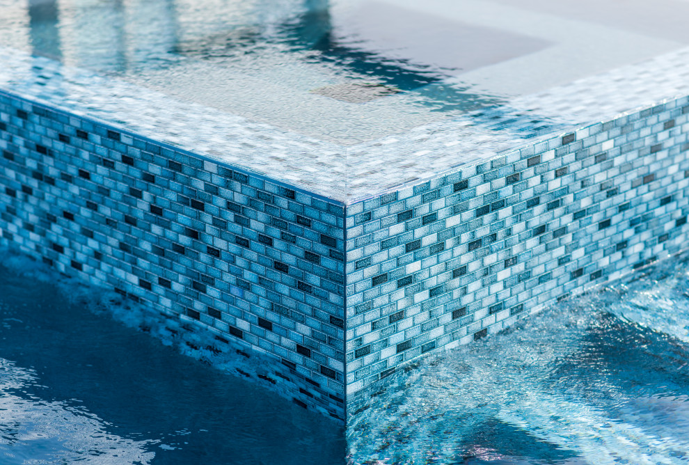 Inspiration for a mid-sized transitional backyard stone and custom-shaped pool remodel in Dallas