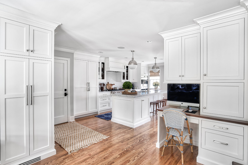 Large transitional l-shaped light wood floor and beige floor eat-in kitchen photo in New York with an undermount sink, beaded inset cabinets, white cabinets, marble countertops, white backsplash, subway tile backsplash, stainless steel appliances, an island and gray countertops