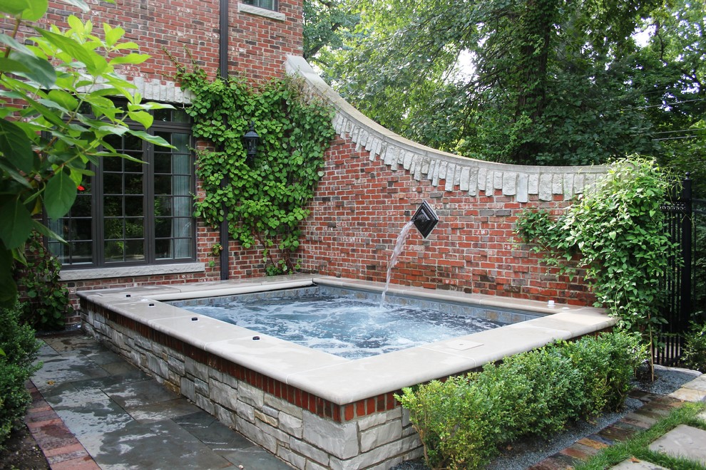 Design ideas for a mid-sized traditional side yard rectangular pool in Chicago with a hot tub.