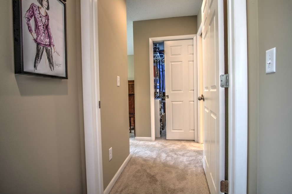 Design ideas for a mid-sized traditional hallway in Minneapolis with beige walls and carpet.