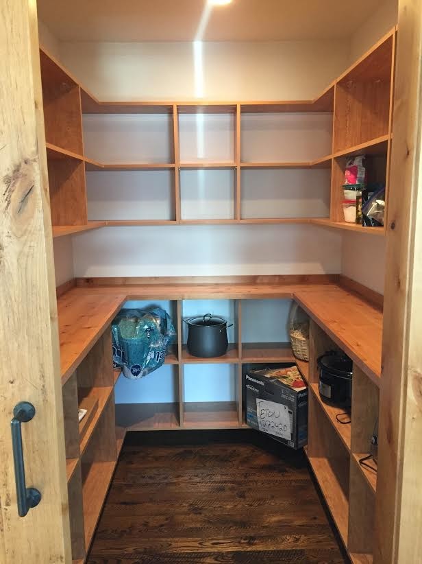 Mountain style kitchen pantry photo with open cabinets and light wood cabinets