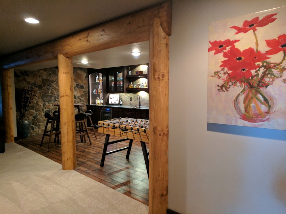 Inspiration for a large rustic underground medium tone wood floor and brown floor basement remodel with gray walls and no fireplace