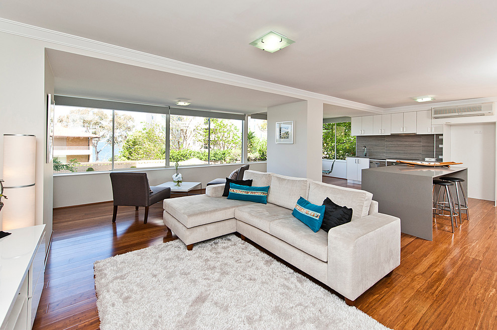 Contemporary open concept living room in Perth with grey walls.