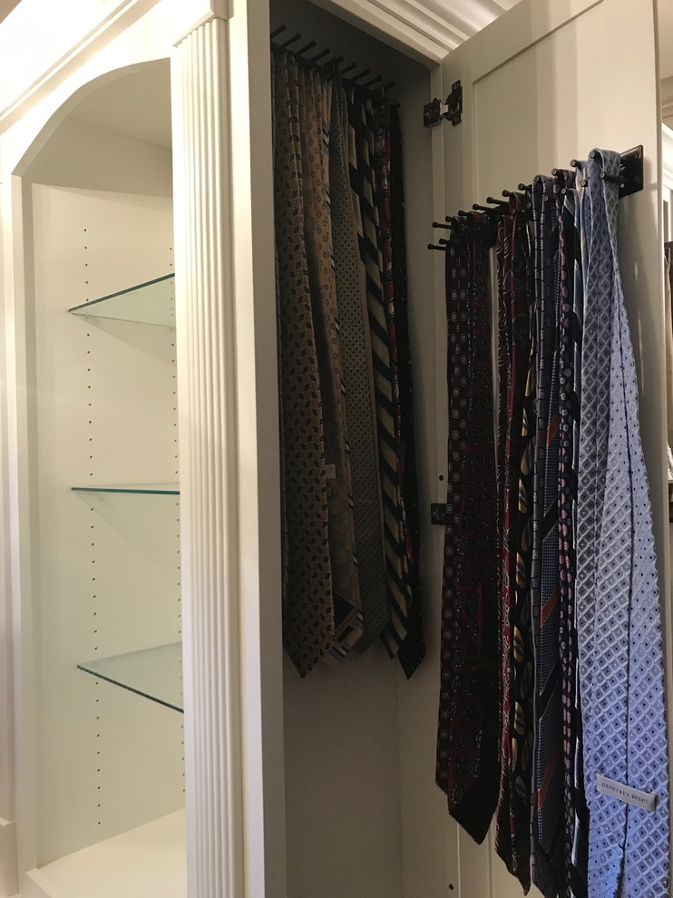 Inspiration for an expansive transitional gender-neutral walk-in wardrobe in Atlanta with recessed-panel cabinets, white cabinets, carpet and beige floor.