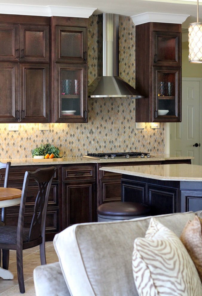 Large transitional l-shaped travertine floor open concept kitchen photo in Sacramento with an undermount sink, glass-front cabinets, dark wood cabinets, quartz countertops, multicolored backsplash, mosaic tile backsplash, stainless steel appliances and an island