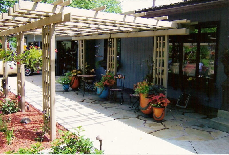 Small country backyard patio in Minneapolis with a pergola.