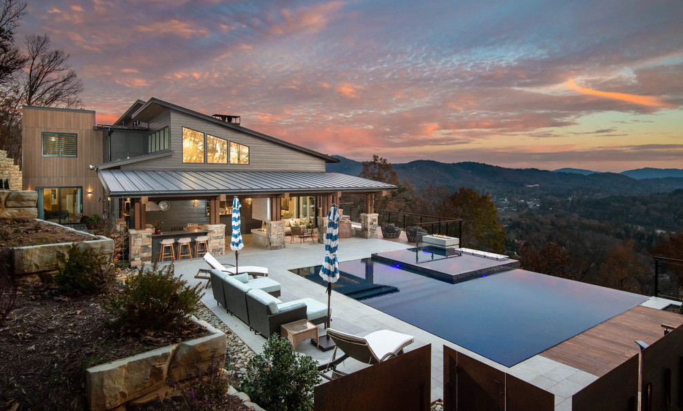 Photo of a contemporary rectangular infinity pool in Other with a hot tub and tile.