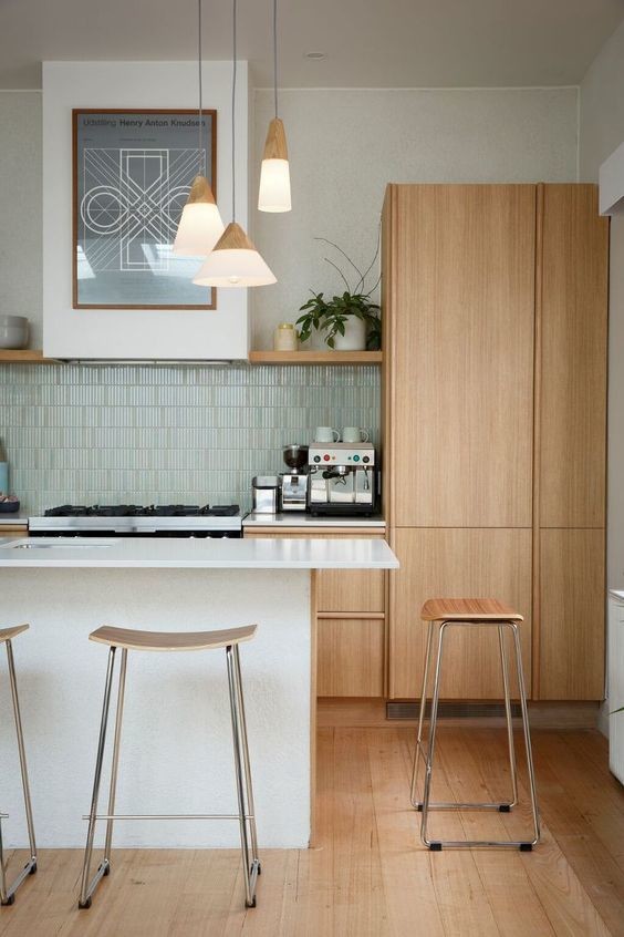 Inspiration for a large transitional single-wall open plan kitchen in Bordeaux with an undermount sink, beaded inset cabinets, medium wood cabinets, marble benchtops, white splashback, ceramic splashback, white appliances, ceramic floors, with island and green floor.