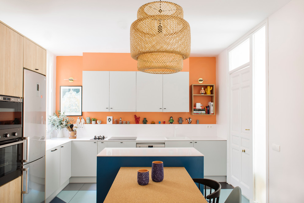 Mid-sized contemporary l-shaped eat-in kitchen in Madrid with a drop-in sink, flat-panel cabinets, grey cabinets, quartz benchtops, white splashback, stone slab splashback, stainless steel appliances, with island and ceramic floors.