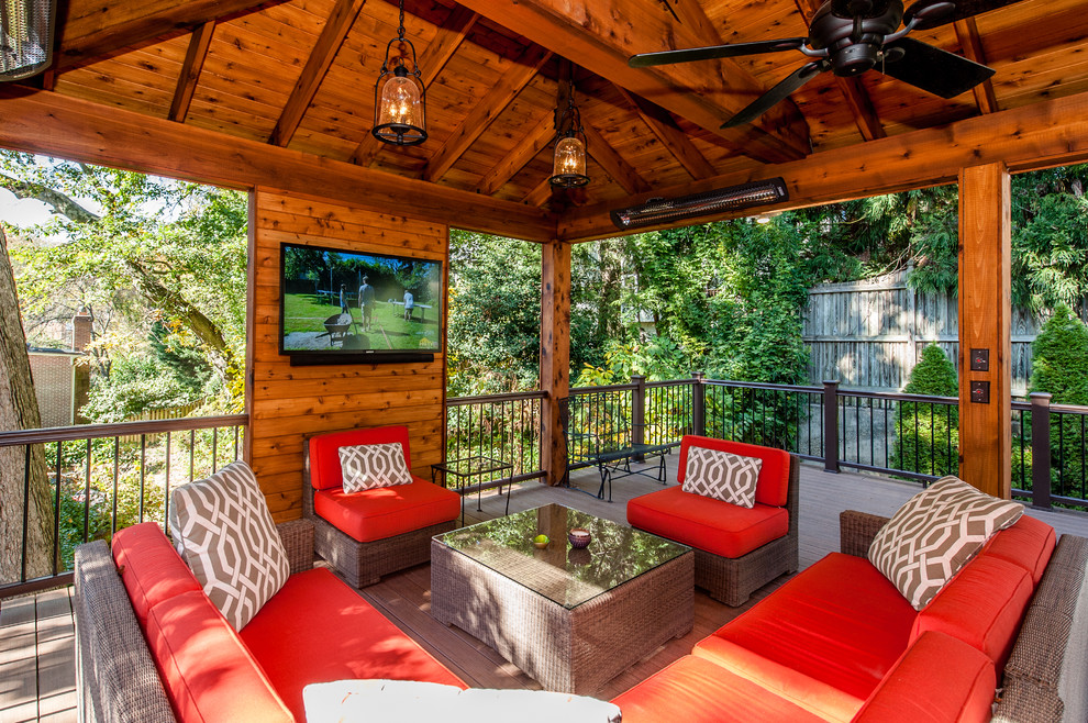 This is an example of a mid-sized country backyard patio in DC Metro with decking and a gazebo/cabana.