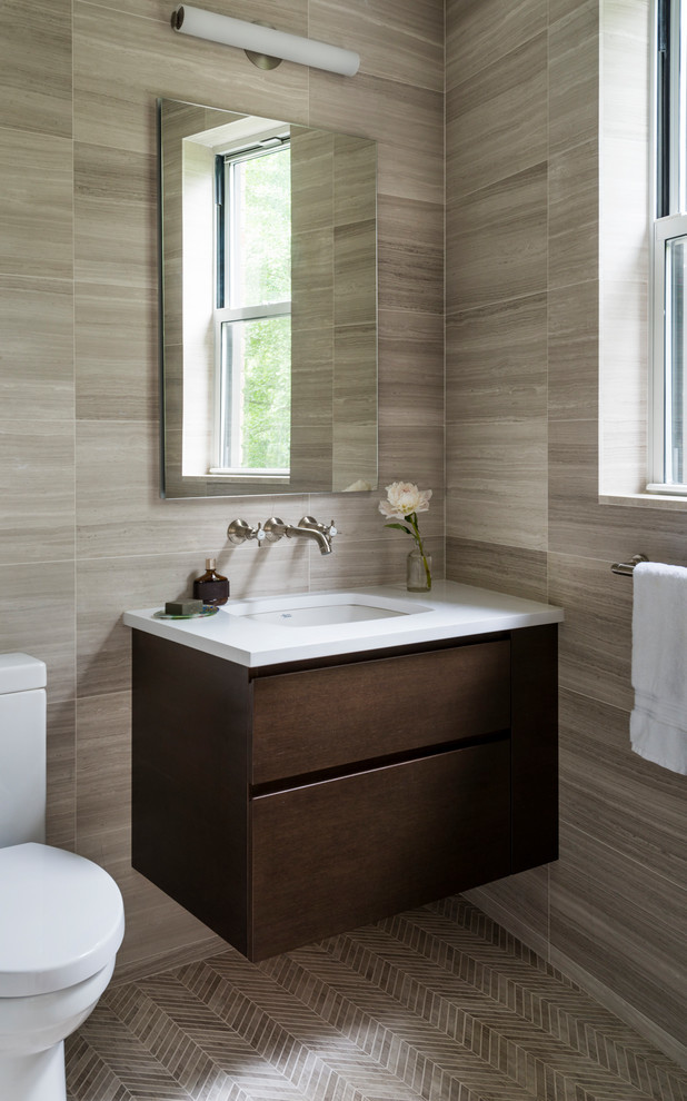 Design ideas for a small transitional powder room in New York with dark wood cabinets, a one-piece toilet, stone tile, beige walls, mosaic tile floors, an undermount sink, quartzite benchtops, grey floor, white benchtops, flat-panel cabinets and gray tile.