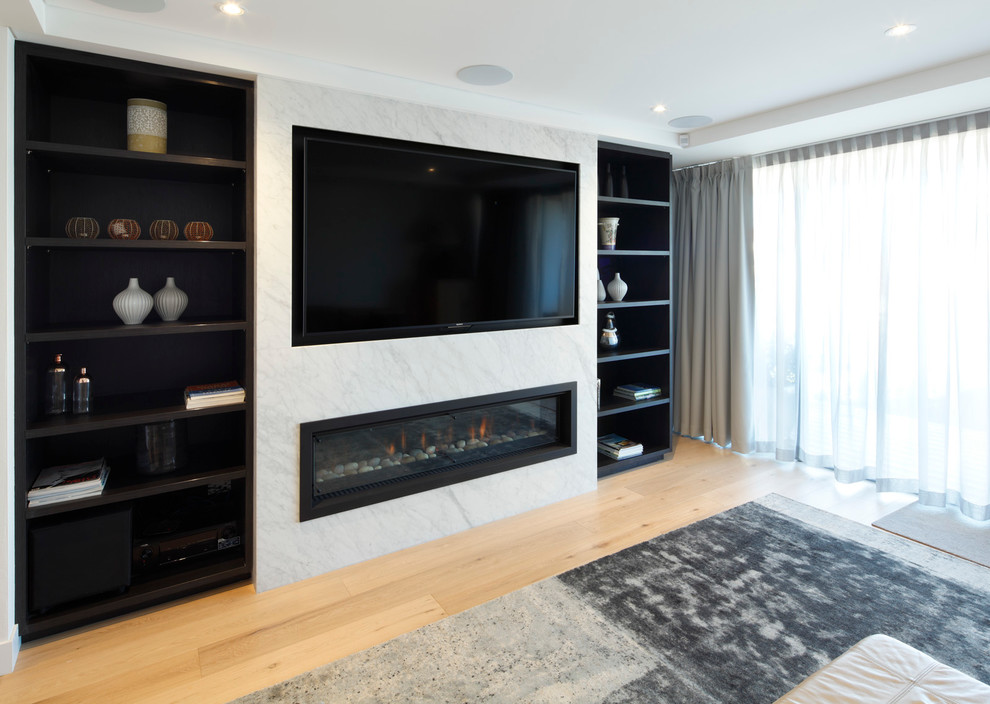 Inspiration for a small contemporary open concept home theatre in Sydney with white walls, medium hardwood floors and a wall-mounted tv.