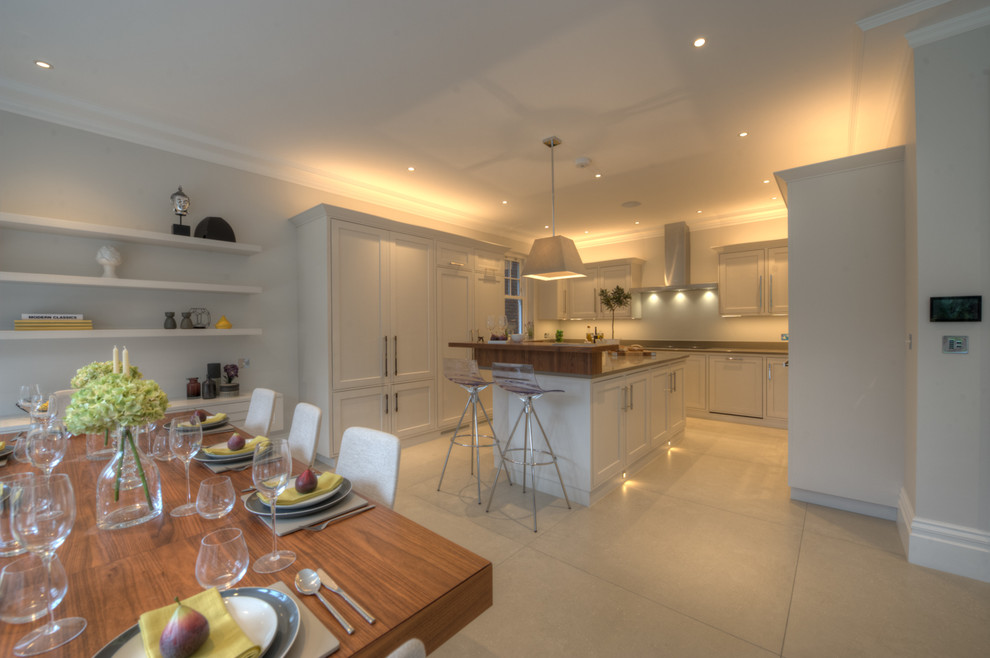 Photo of an expansive contemporary l-shaped eat-in kitchen in London with a drop-in sink, recessed-panel cabinets, grey cabinets, panelled appliances, porcelain floors and with island.