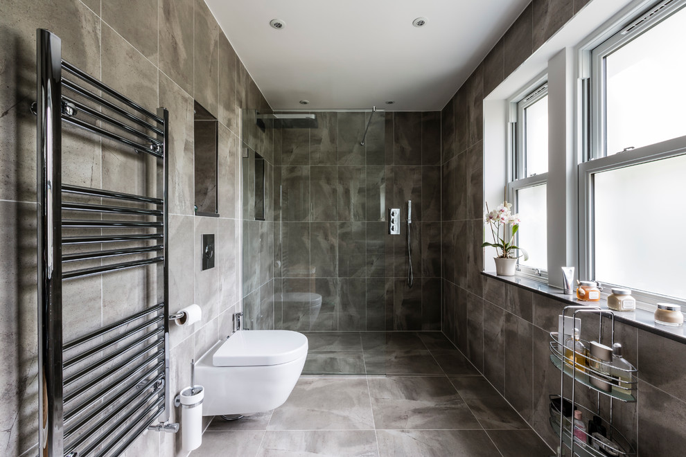 This is an example of a contemporary bathroom in Surrey with gray tile and a curbless shower.