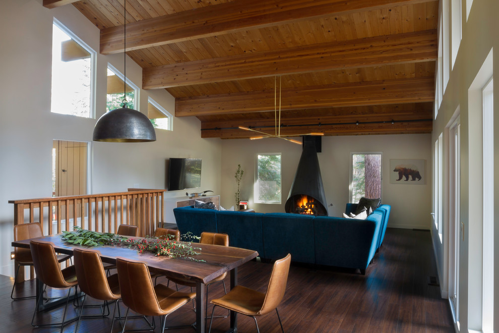 This is an example of a large contemporary dining room in San Francisco with white walls and a wood stove.
