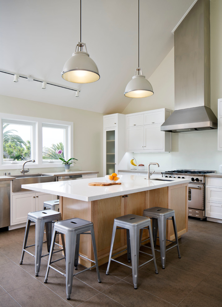 Photo of a contemporary u-shaped kitchen in San Diego with a farmhouse sink, shaker cabinets, white cabinets, white splashback, stainless steel appliances and glass sheet splashback.