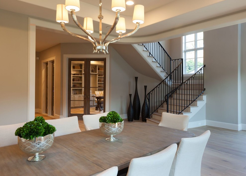 Inspiration for a large country separate dining room in Houston with white walls, light hardwood floors and brown floor.
