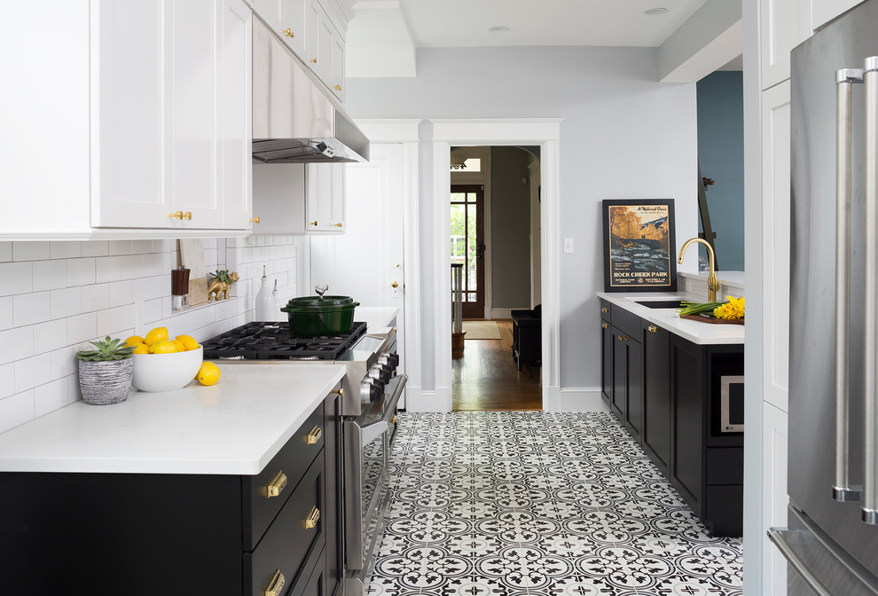 Eat-in kitchen - mid-sized transitional black floor eat-in kitchen idea in DC Metro with black cabinets, white backsplash, subway tile backsplash and stainless steel appliances