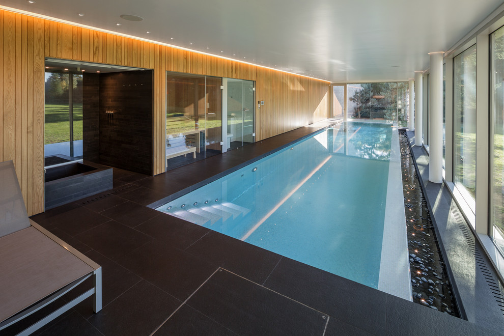 Photo of a contemporary rectangular lap pool in Oxfordshire with a pool house.