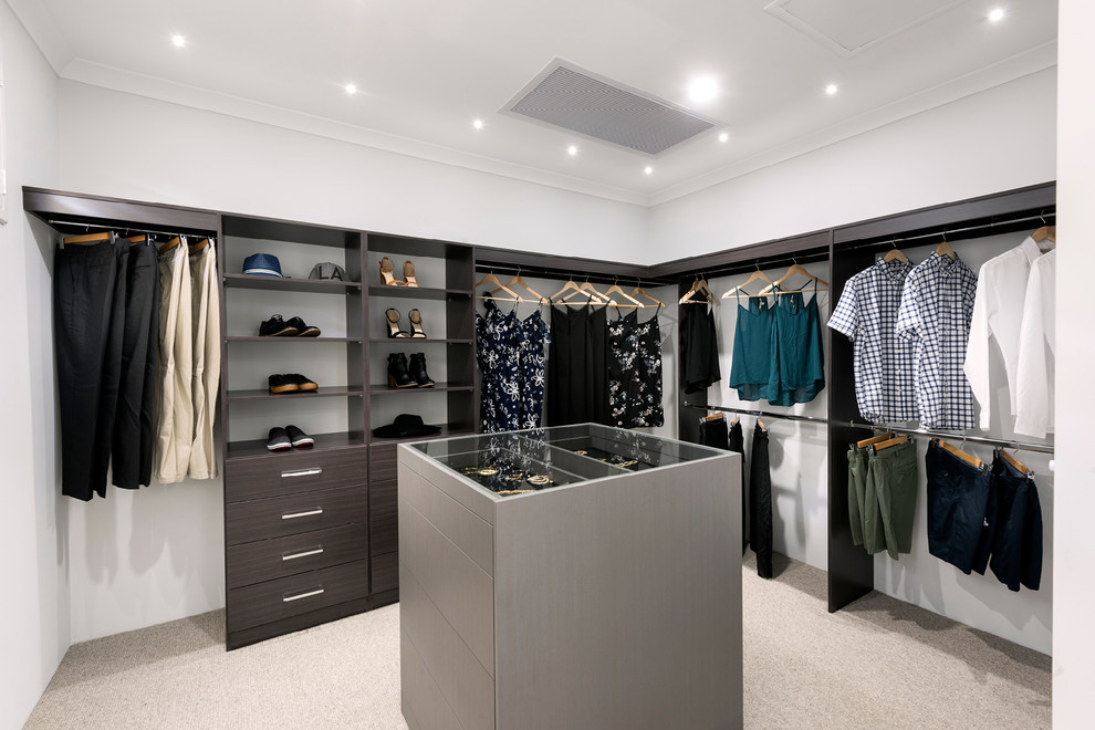 Design ideas for a large contemporary gender-neutral dressing room in Perth with open cabinets, dark wood cabinets, carpet and beige floor.