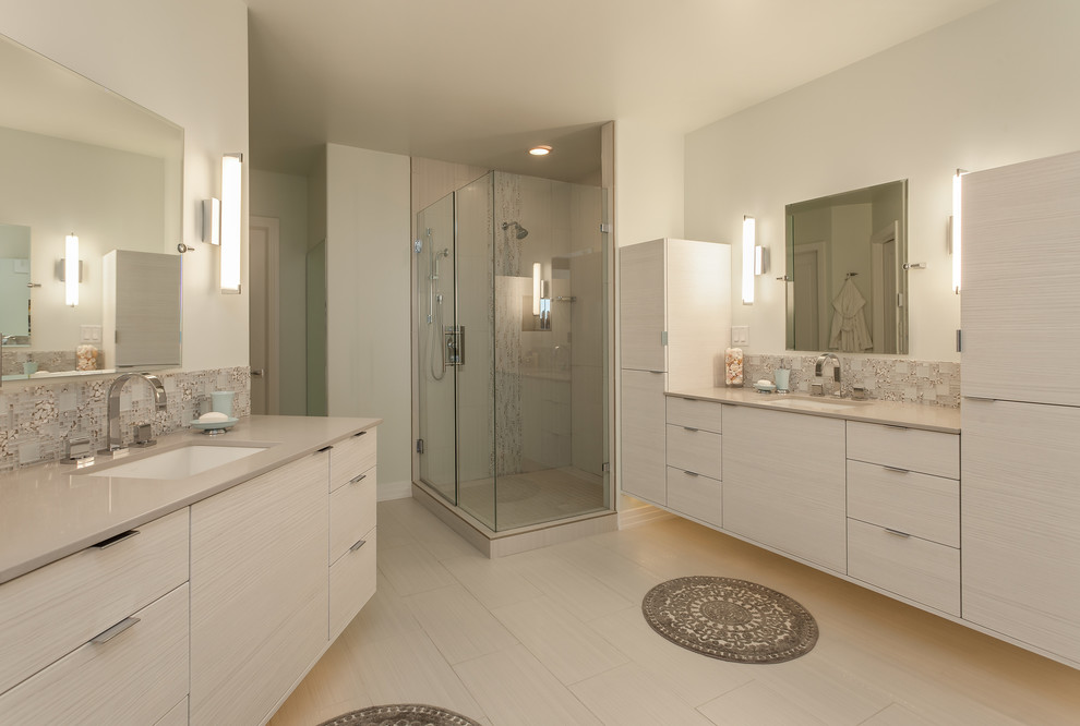 Large contemporary master bathroom in Denver with an undermount sink, flat-panel cabinets, light wood cabinets, engineered quartz benchtops, a freestanding tub, a corner shower, white tile, porcelain tile, white walls and porcelain floors.