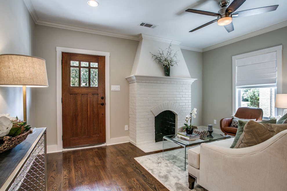 Mid-sized arts and crafts formal open concept living room in Dallas with beige walls, medium hardwood floors, a standard fireplace, a brick fireplace surround and brown floor.