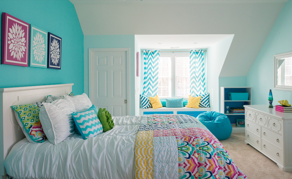 Photo of a large transitional kids' room for girls in New York with blue walls, carpet and beige floor.