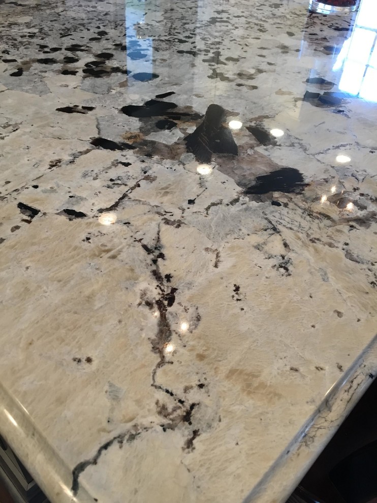 Example of a large transitional dark wood floor kitchen design in Indianapolis with an undermount sink, gray cabinets, granite countertops, white backsplash, subway tile backsplash and stainless steel appliances