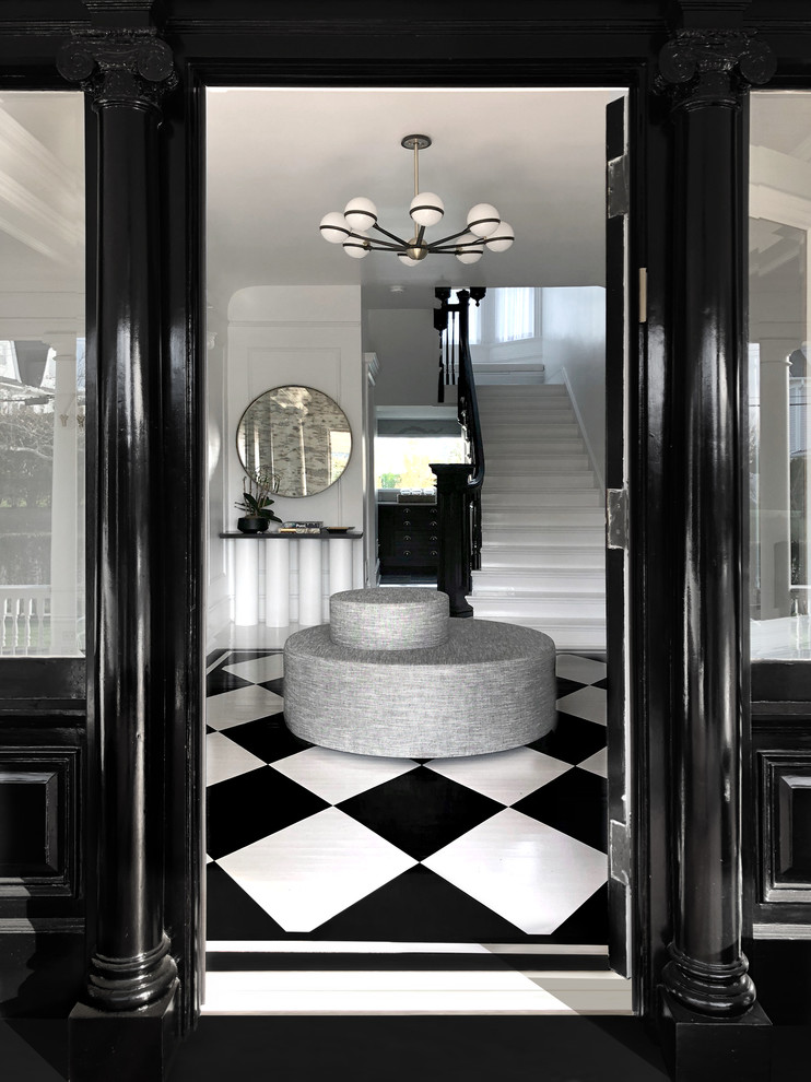 Expansive transitional foyer in New York with white walls, a single front door, a black front door and multi-coloured floor.